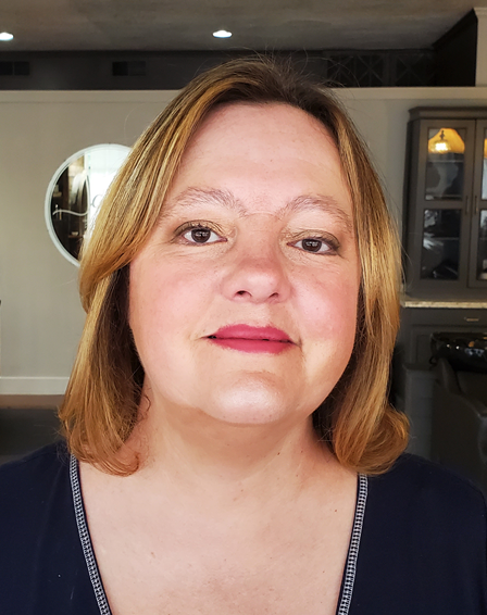 A woman facing the camera smiling with medium length hair